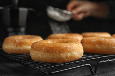 Photo of Sweet delicious glazed donuts on black table