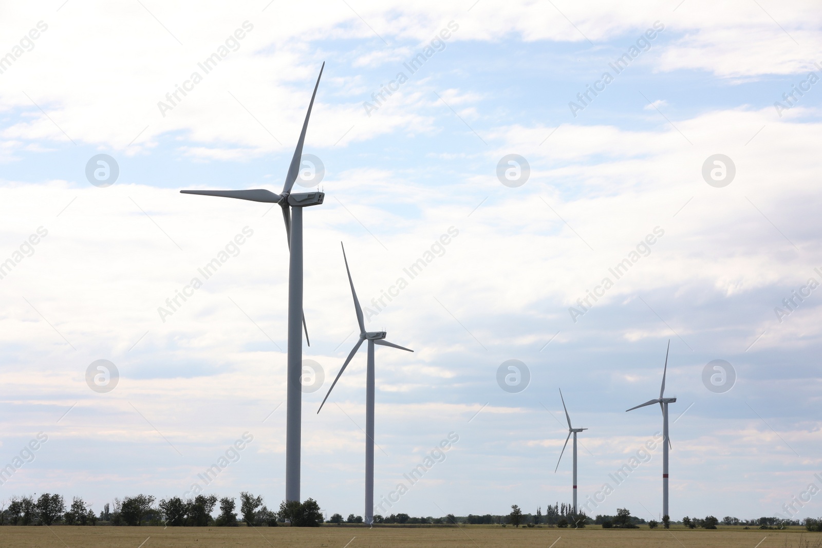 Photo of Beautiful view of field with wind turbines. Alternative energy source