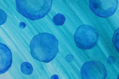 Abstract watercolor painting with blue blots as background, top view