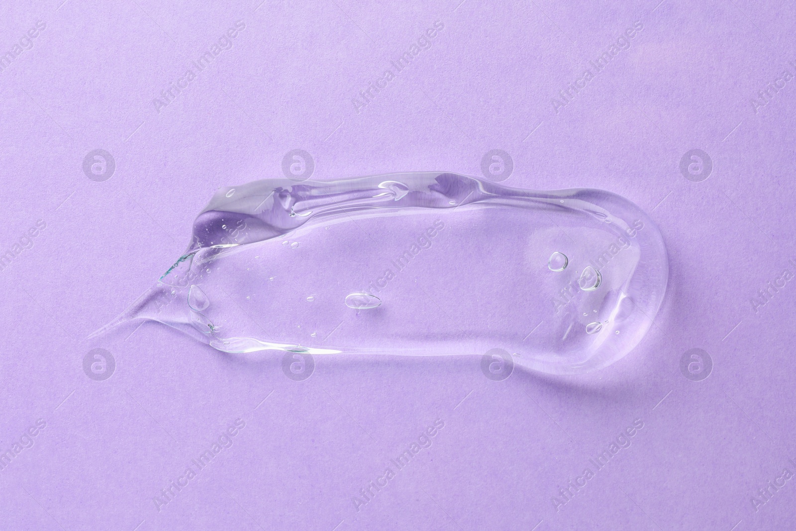 Photo of Clear cosmetic gel on violet background, top view