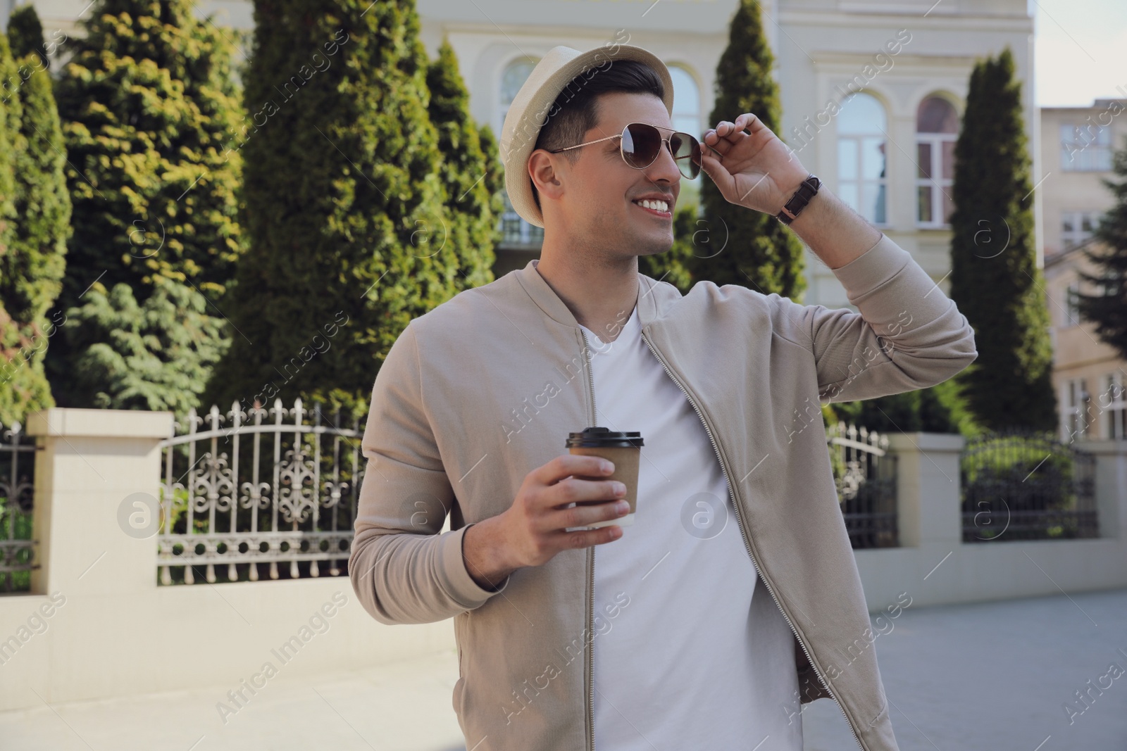 Photo of Tourist with cup of coffee on city street