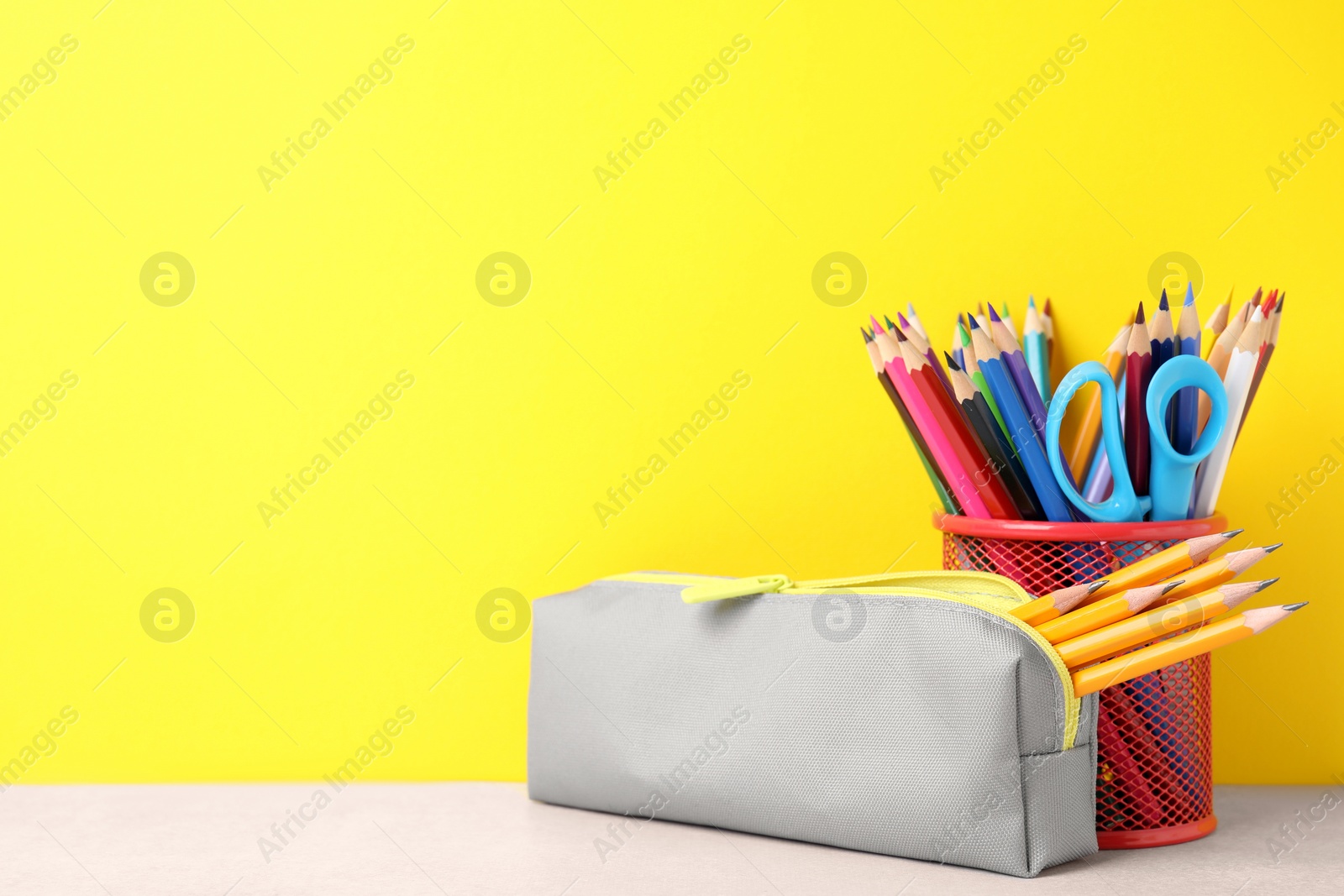 Photo of Different school stationery on white table against yellow background, space for text. Back to school