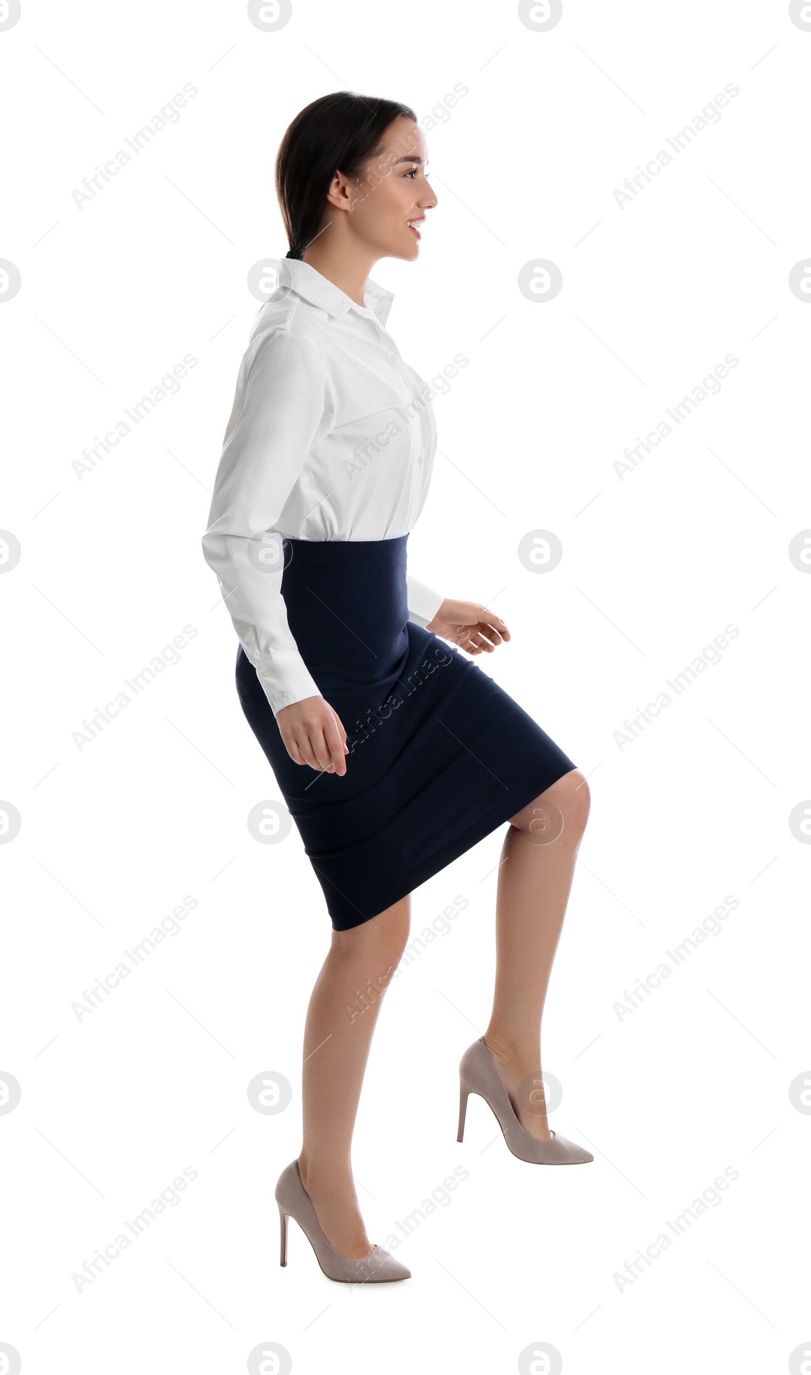 Photo of Businesswoman imitating stepping up on stairs against white background. Career ladder concept