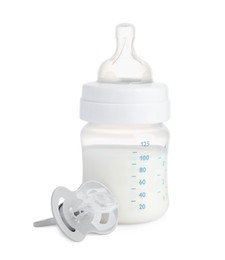 Photo of Bottle with milk and baby pacifier on white background