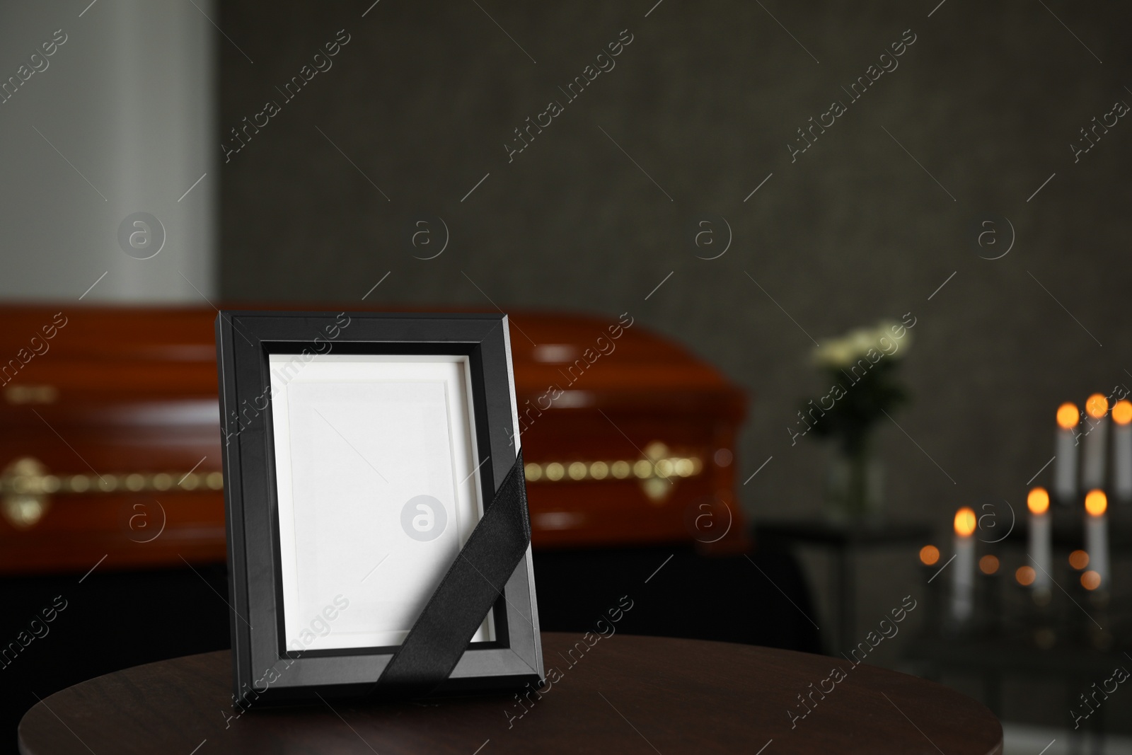 Photo of Black photo frame on table in funeral home