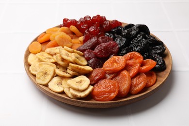 Delicious dried fruits on white table, closeup