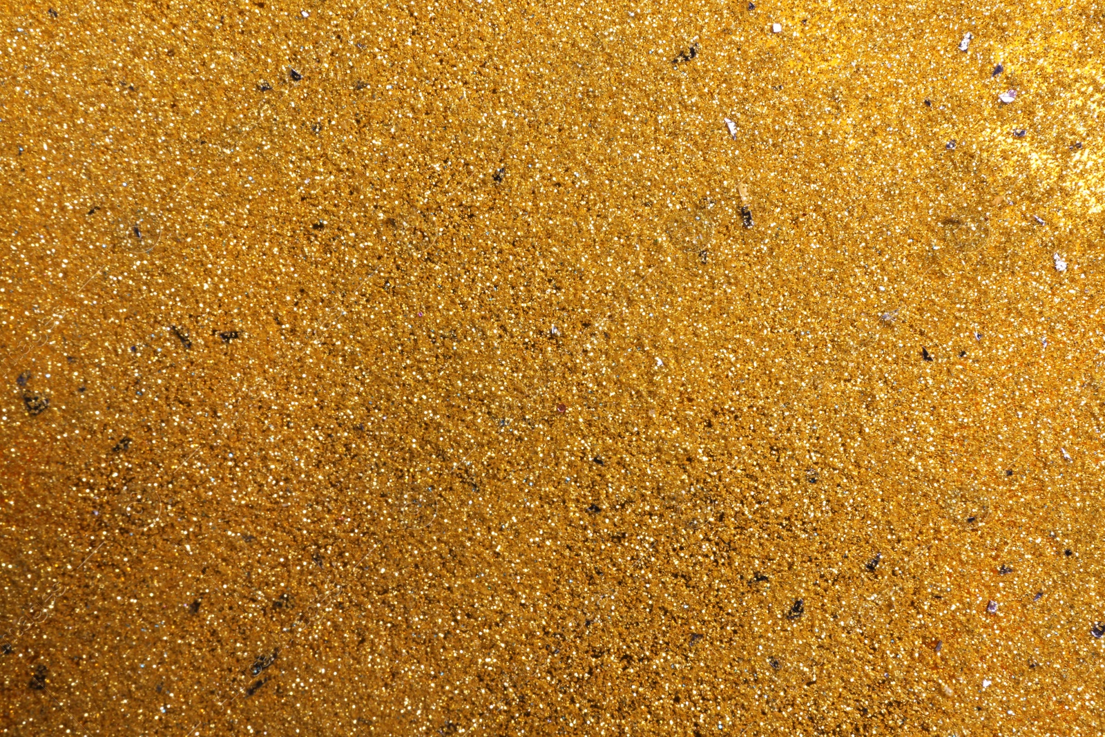 Photo of Shiny golden sand as background, top view