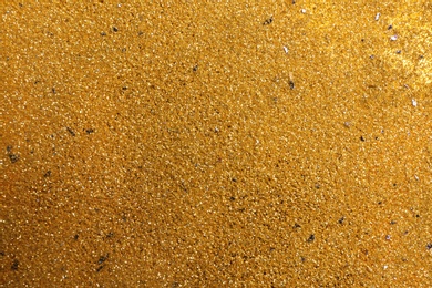 Shiny golden sand as background, top view