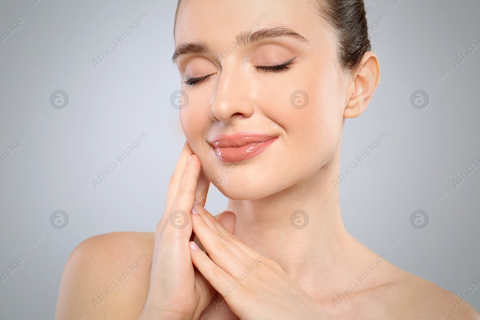 Photo of Portrait of beautiful young woman with perfect skin on grey background, closeup. Spa treatment