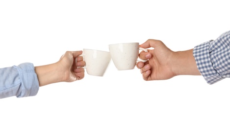 Photo of Women clinking cups on white background, closeup