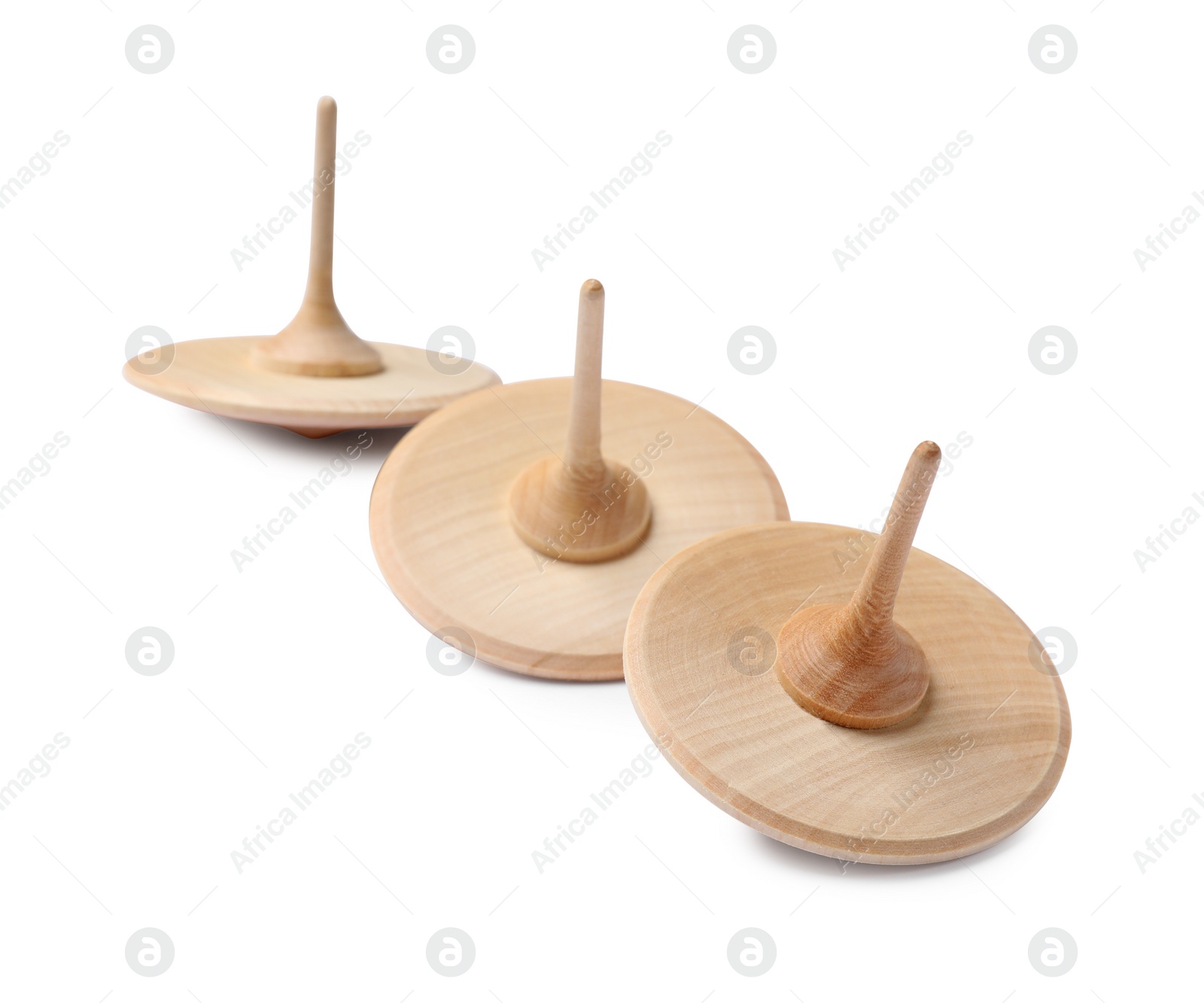 Photo of Many wooden spinning tops isolated on white