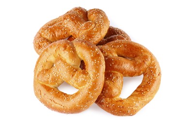 Tasty freshly baked pretzels on white background