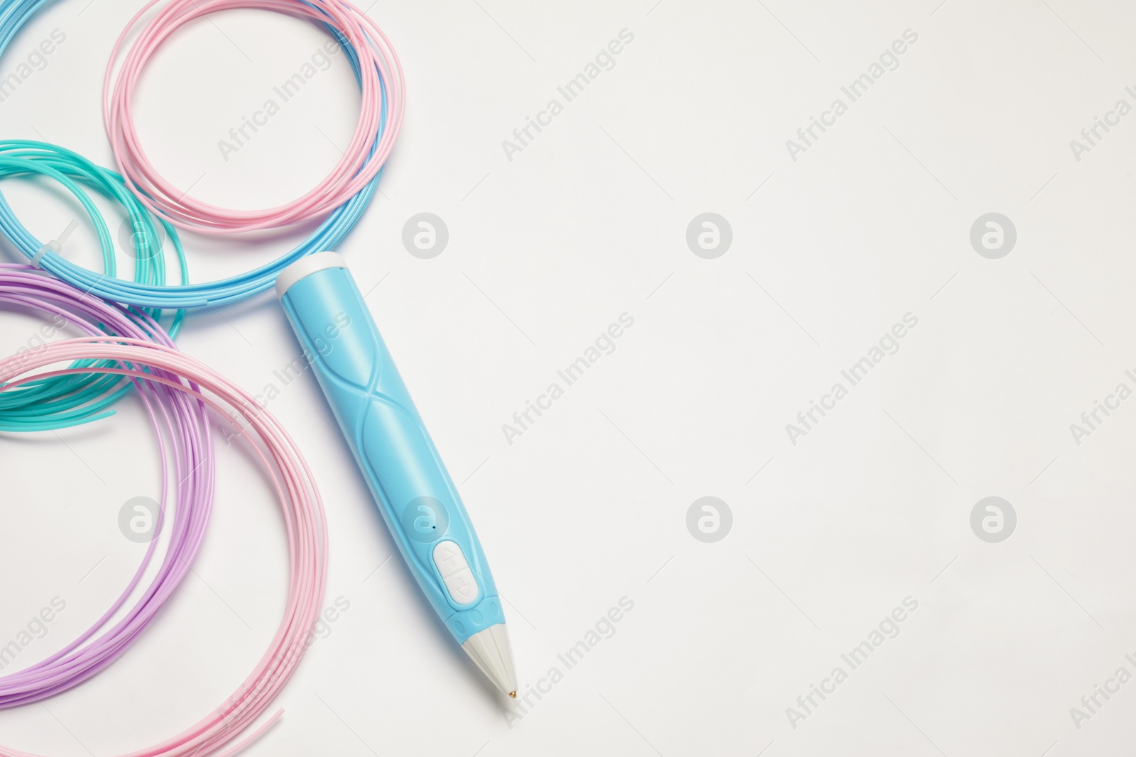 Photo of Stylish 3D pen and colorful plastic filaments on white background, flat lay. Space for text