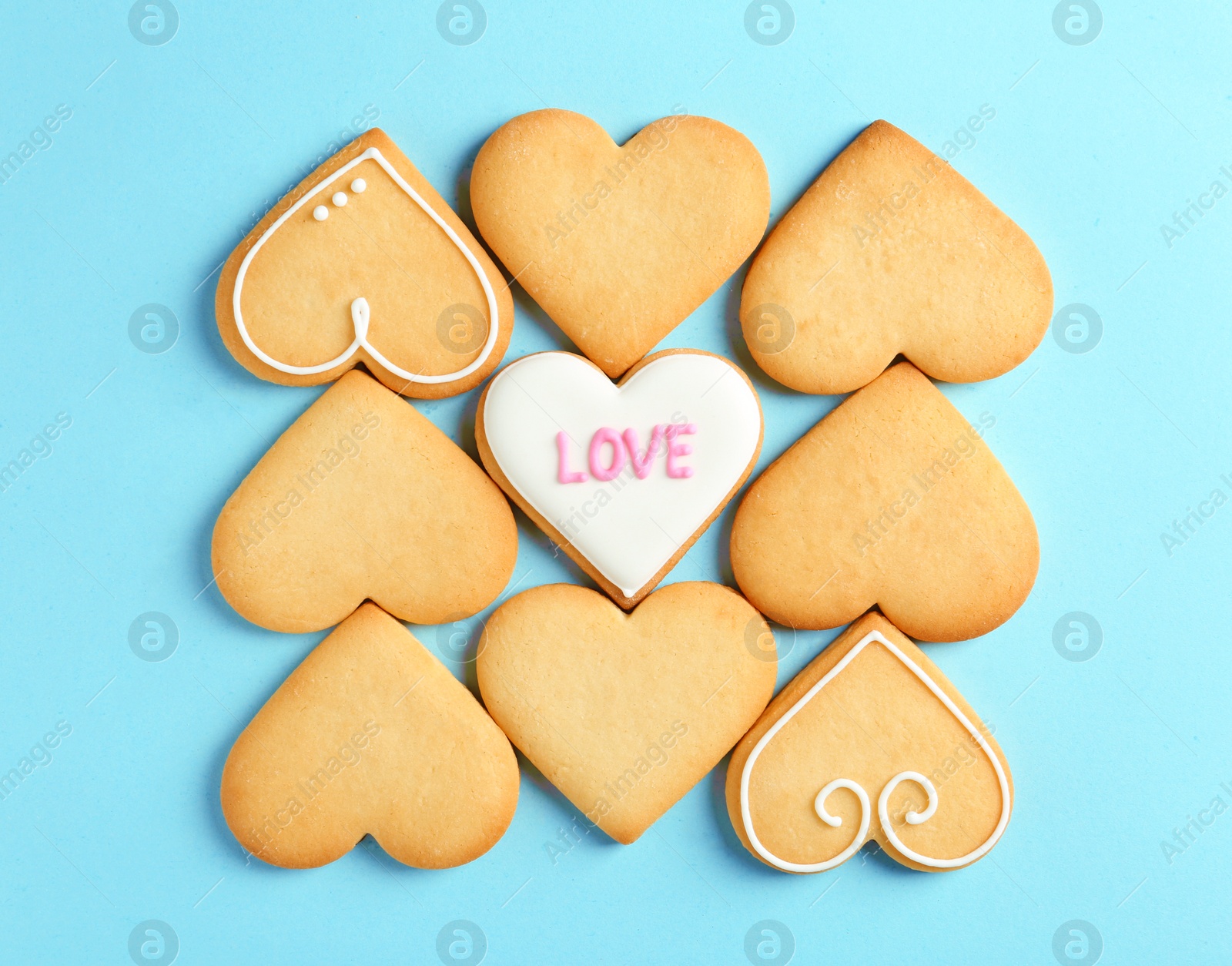 Photo of Decorated heart shaped cookies on color background, top view. Valentine's day treat