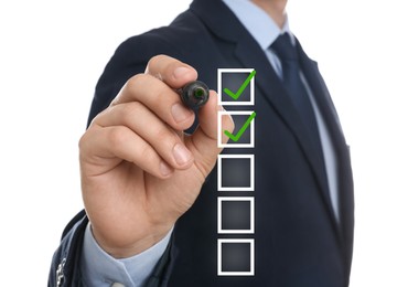 Image of To Do List. Man ticking check boxes with marker on glass board against white background, closeup