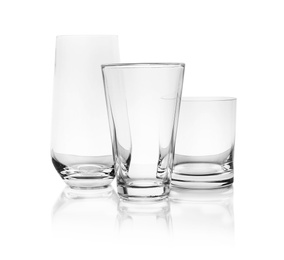 Photo of Set of empty glasses for different drinks on white background