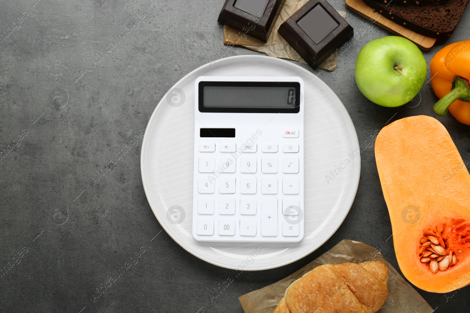 Photo of Calculator and food products on dark grey table, flat lay with space for text. Weight loss concept