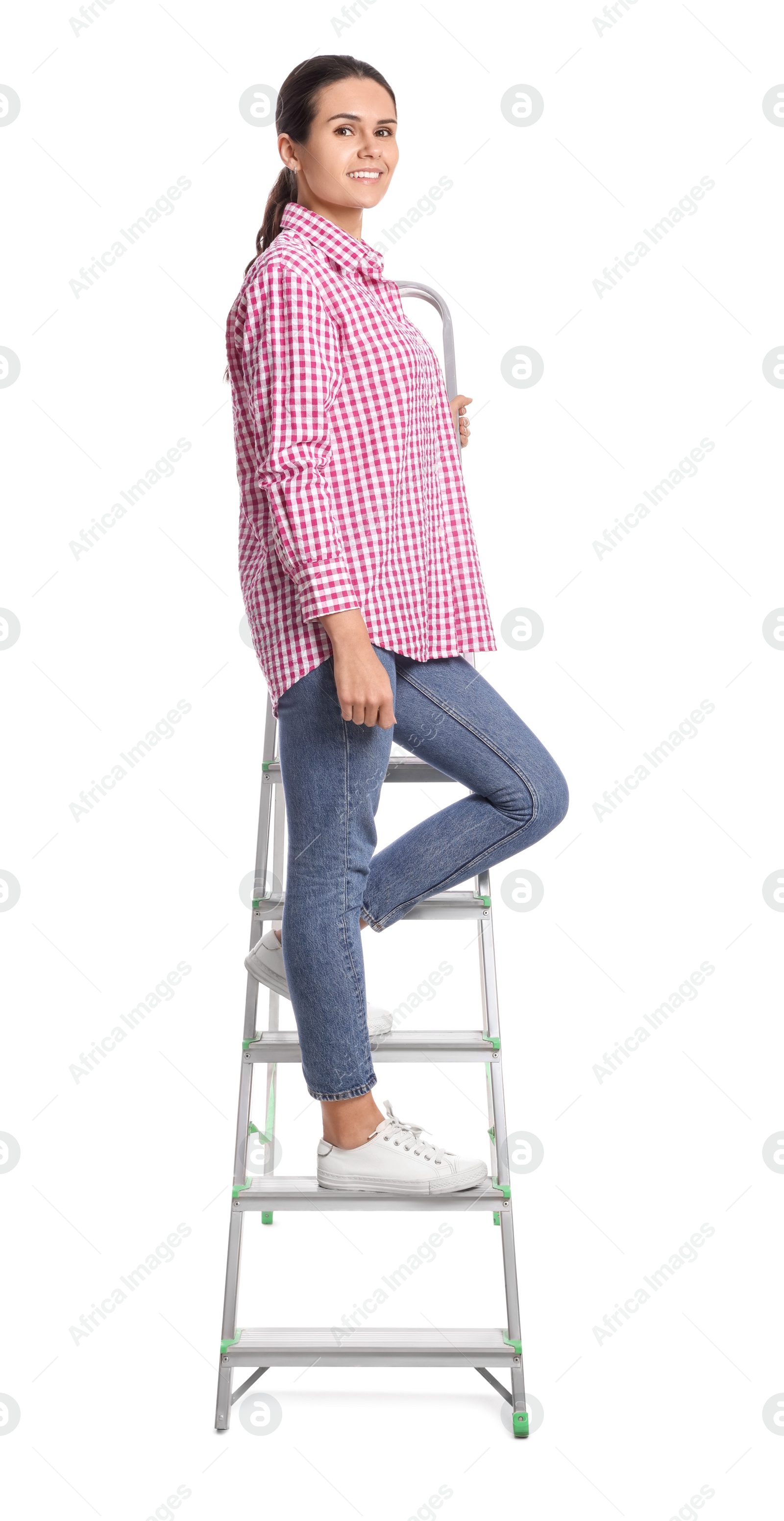 Photo of Young woman on metal ladder against white background