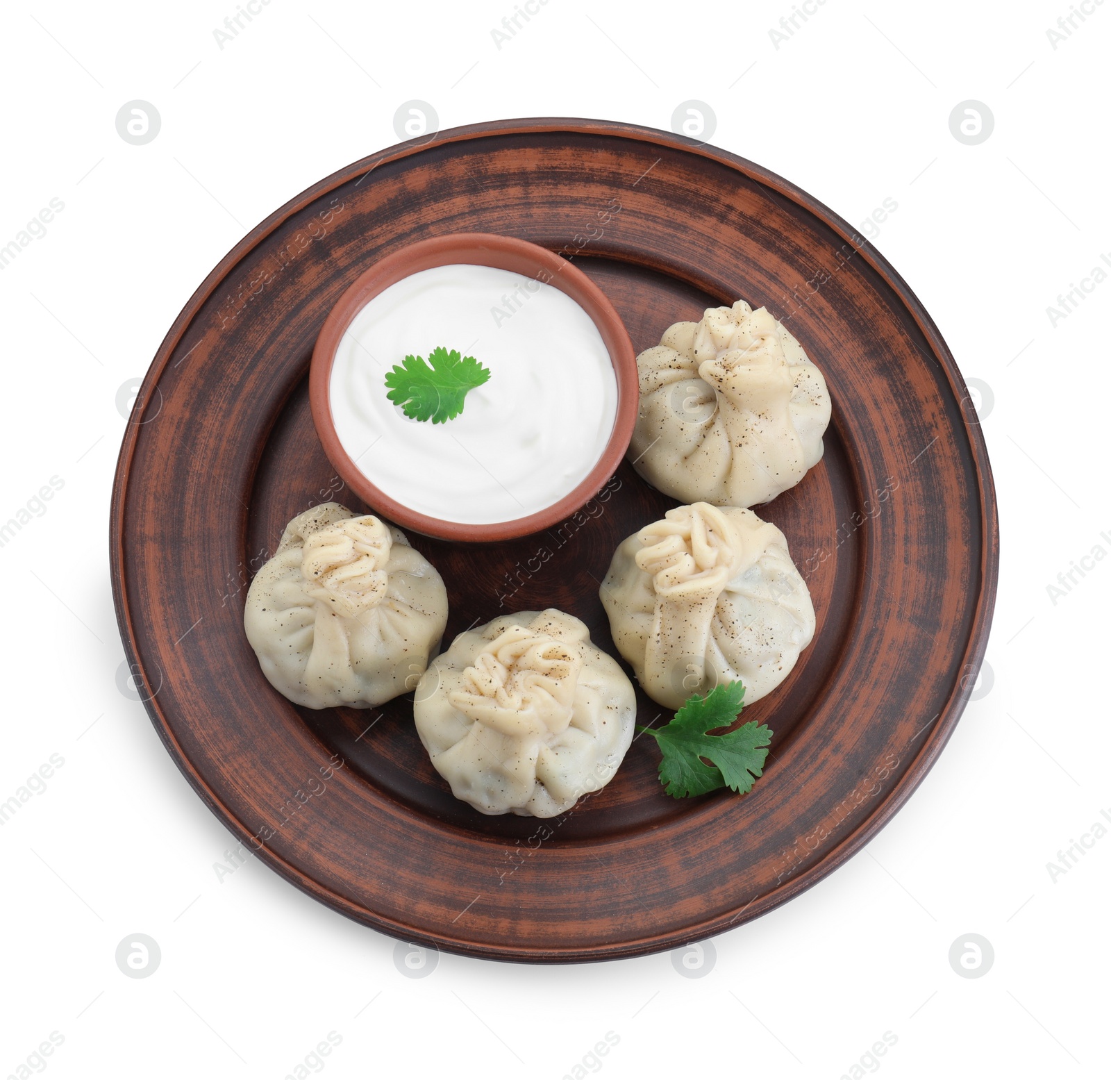 Photo of Tasty khinkali (dumplings) with sauce and spices isolated on white, top view. Georgian cuisine