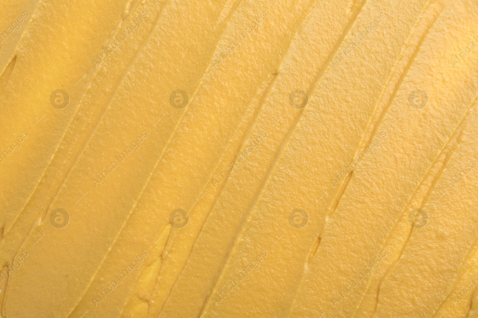 Photo of Fresh tasty mustard sauce as background, top view