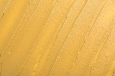 Photo of Fresh tasty mustard sauce as background, top view