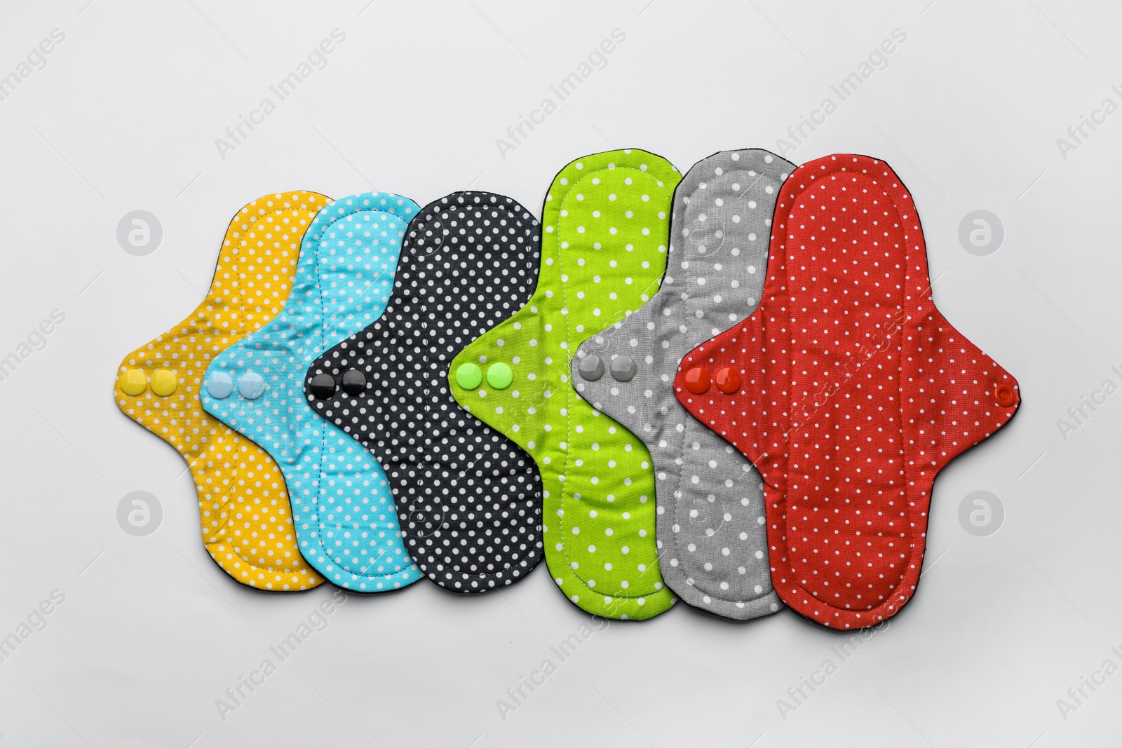 Photo of Many reusable cloth menstrual pads on white background, flat lay