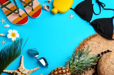 Flat lay composition with sunglasses and beach accessories on blue background. Space for text