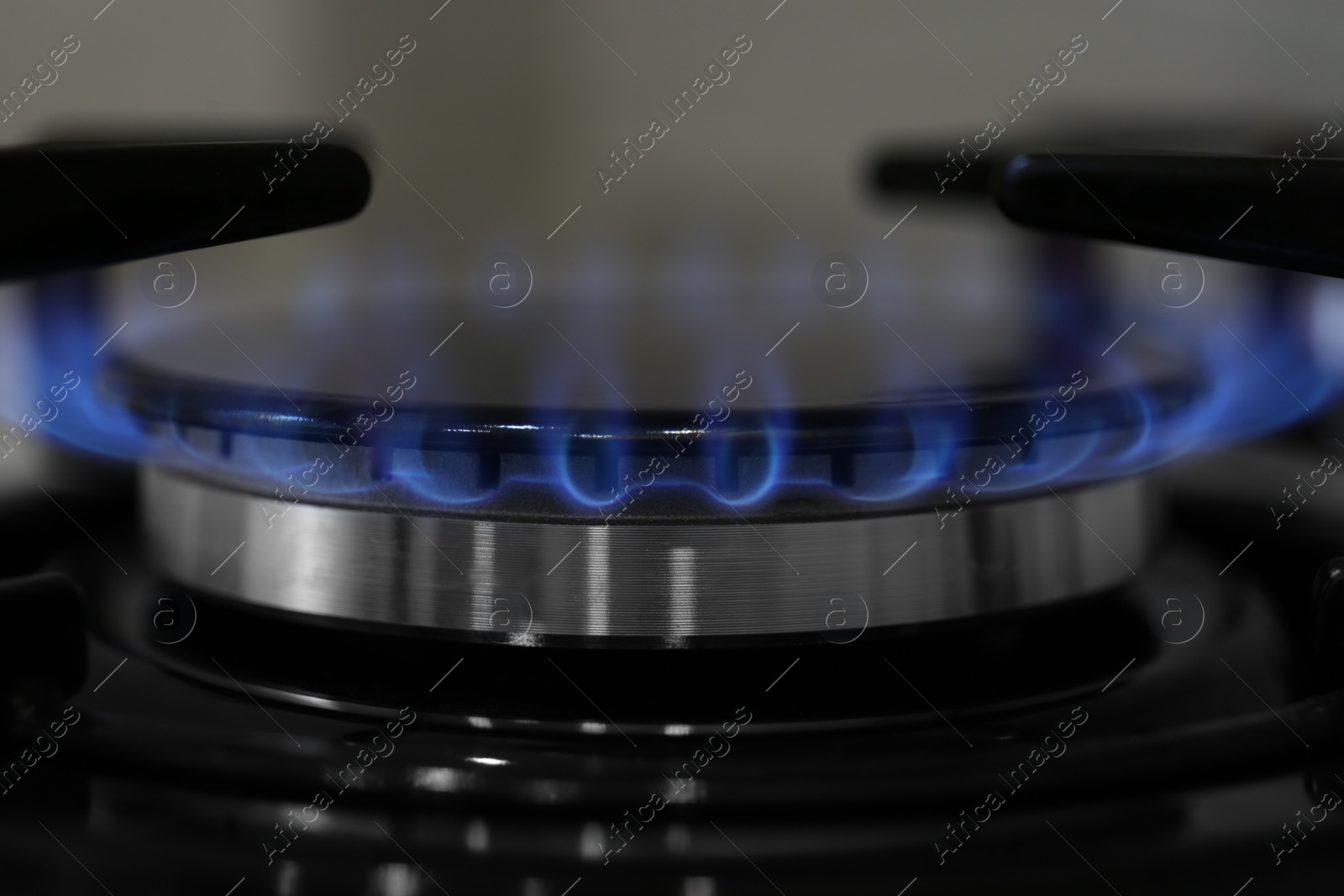 Photo of Modern kitchen stove with burning gas, closeup