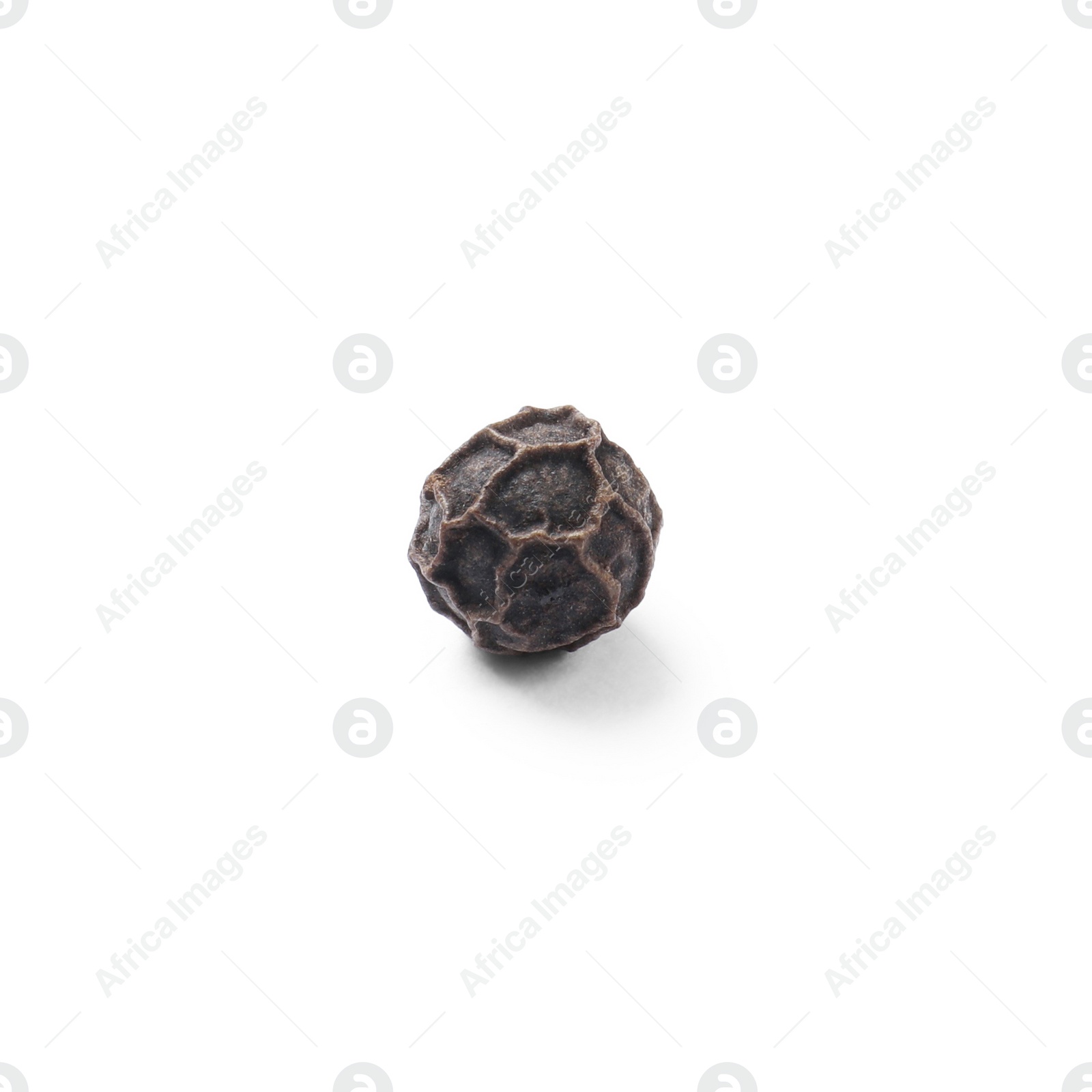 Photo of Aromatic spice. One black peppercorn isolated on white