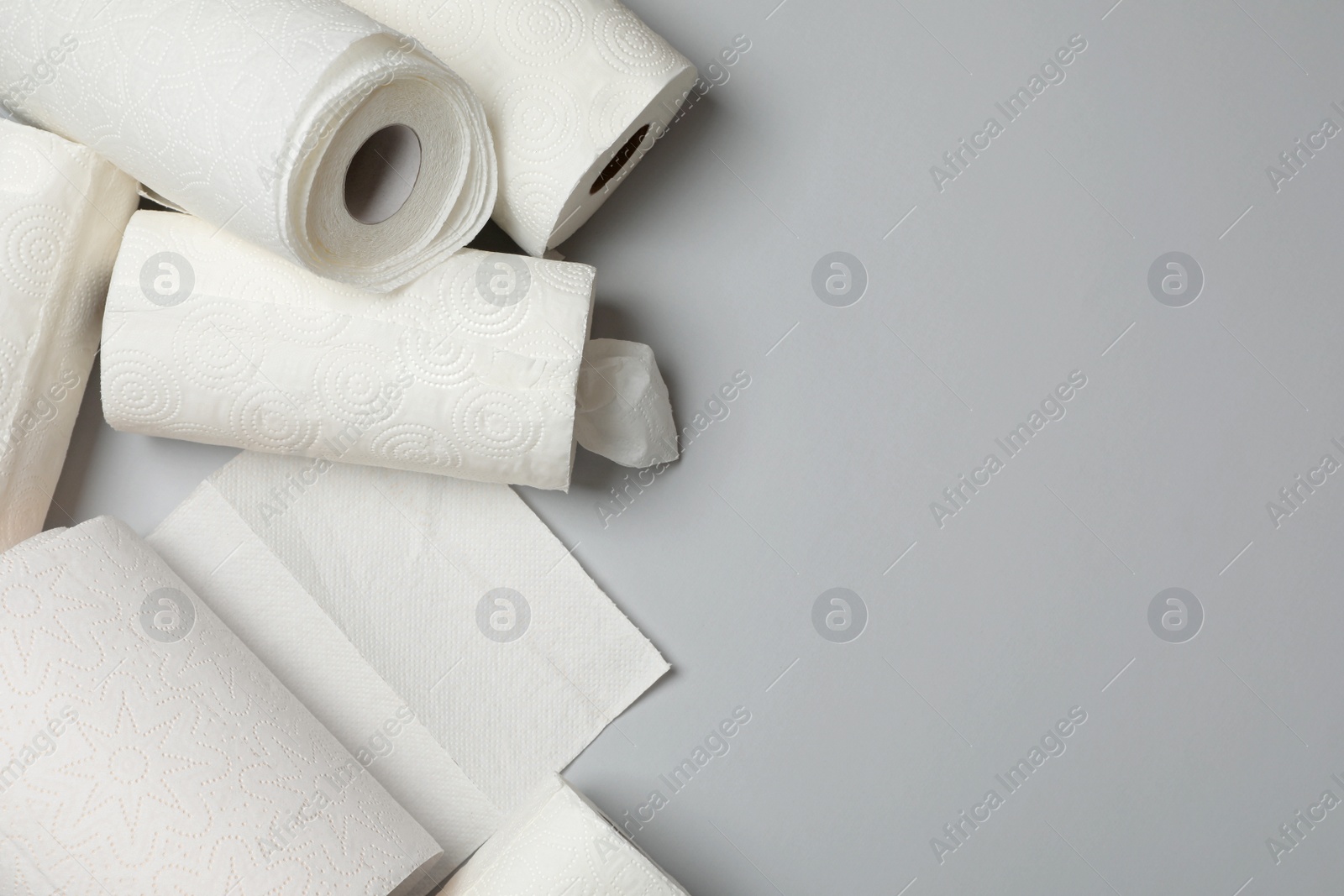 Photo of Many rolls of paper towels on grey background, flat lay. Space for text