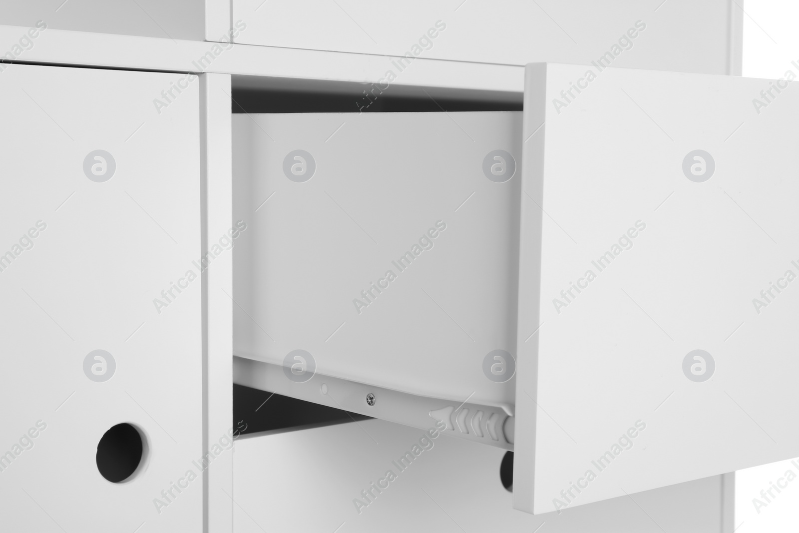 Photo of Stylish dresser with open drawer on white background, closeup. Furniture for wardrobe room