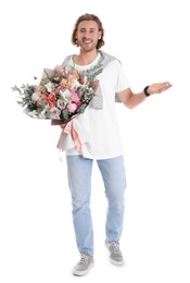 Photo of Young handsome man with beautiful flower bouquet on white background