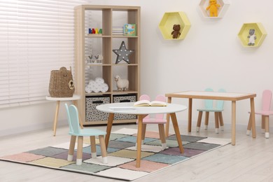 Photo of Stylish kindergarten interior with toys and modern furniture