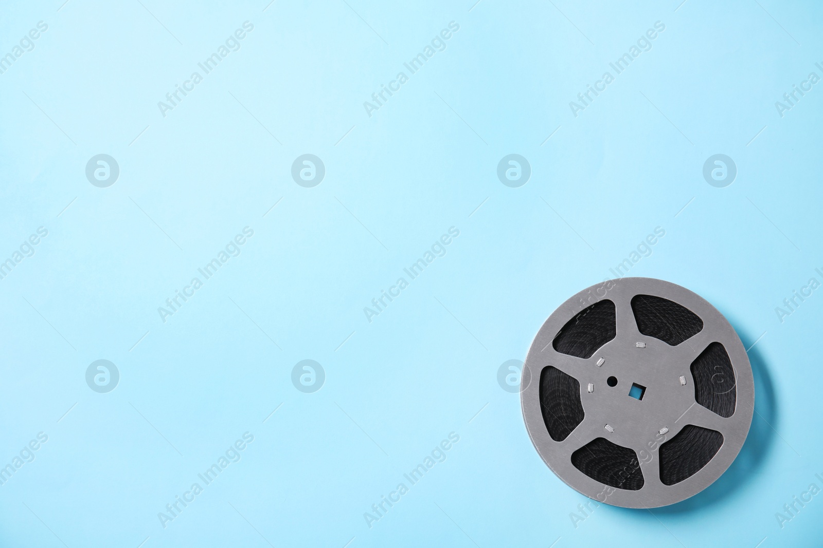 Photo of Movie reel on color background, top view with space for text. Cinema production