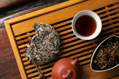 Photo of Traditional tea ceremony arrangement on wooden table, flat lay
