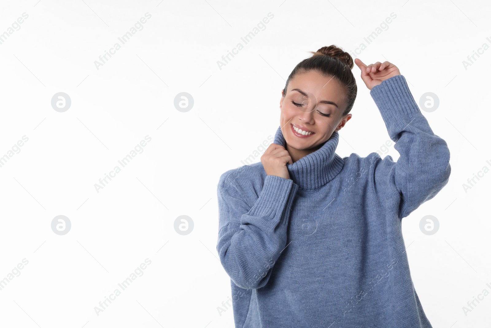 Photo of Young woman in stylish blue sweater on white background