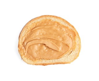 Slice of bread with peanut butter on white background, top view