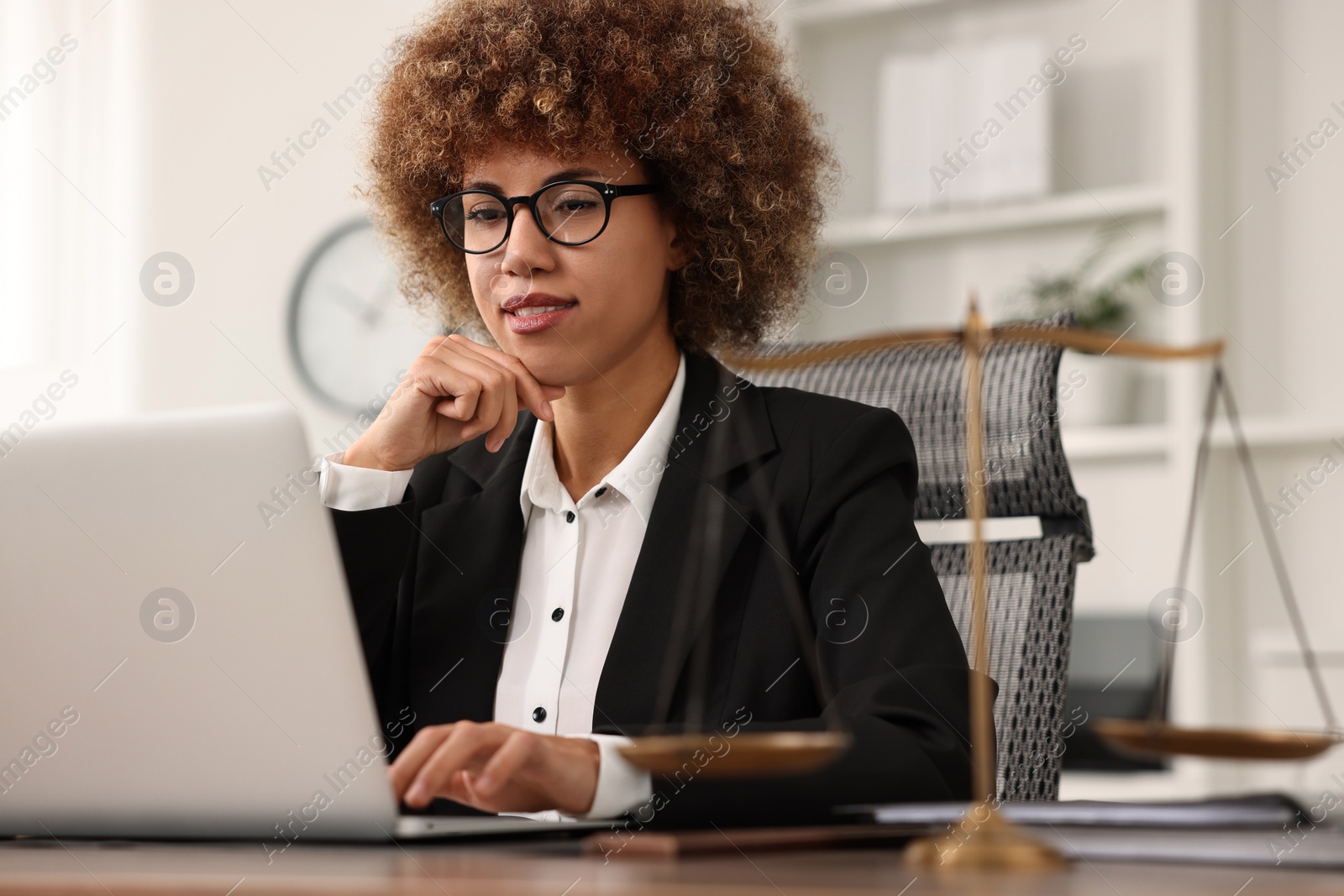 Photo of Notary using laptop at workplace in office