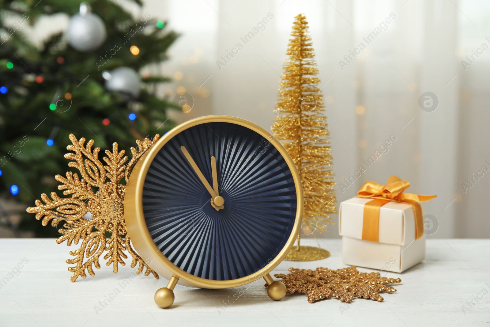 Photo of Clock, gift and festive decor on table. Christmas countdown