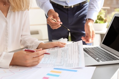 Photo of Tax accountants working with documents at table