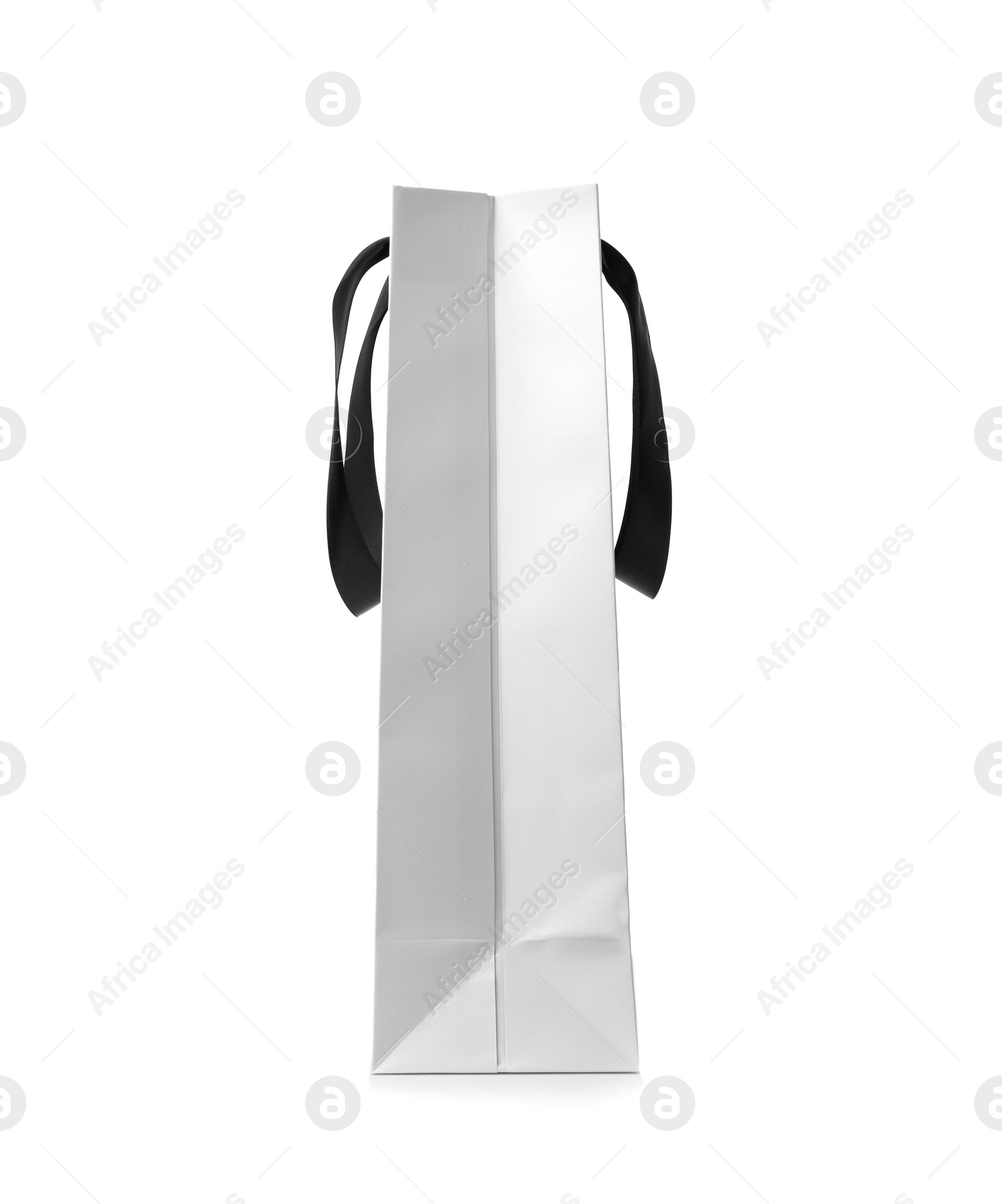 Photo of Paper shopping bag with ribbon handles on white background