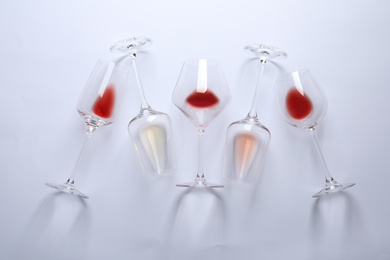 Different glasses with wine on white background, top view