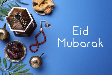 Image of Eid Mubarak greeting card. Flat lay composition with Arabic lantern and misbaha on blue table