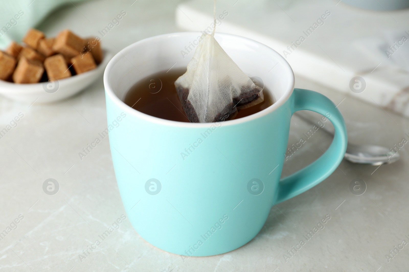 Photo of Cup of delicious hot tea on table