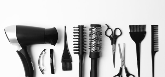 Set of different professional hairdresser tools on white background, flat lay. Banner design