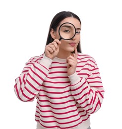 Photo of Confused young woman looking through magnifier glass on white background