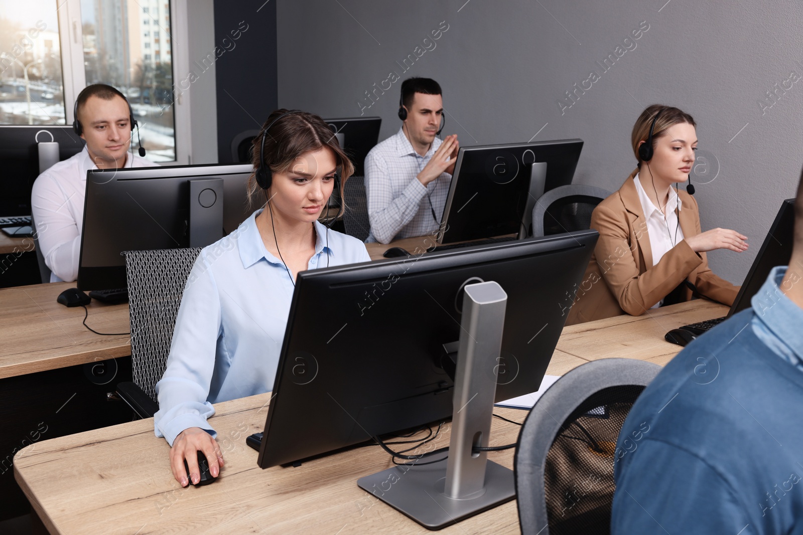 Photo of Call center operator working in modern office