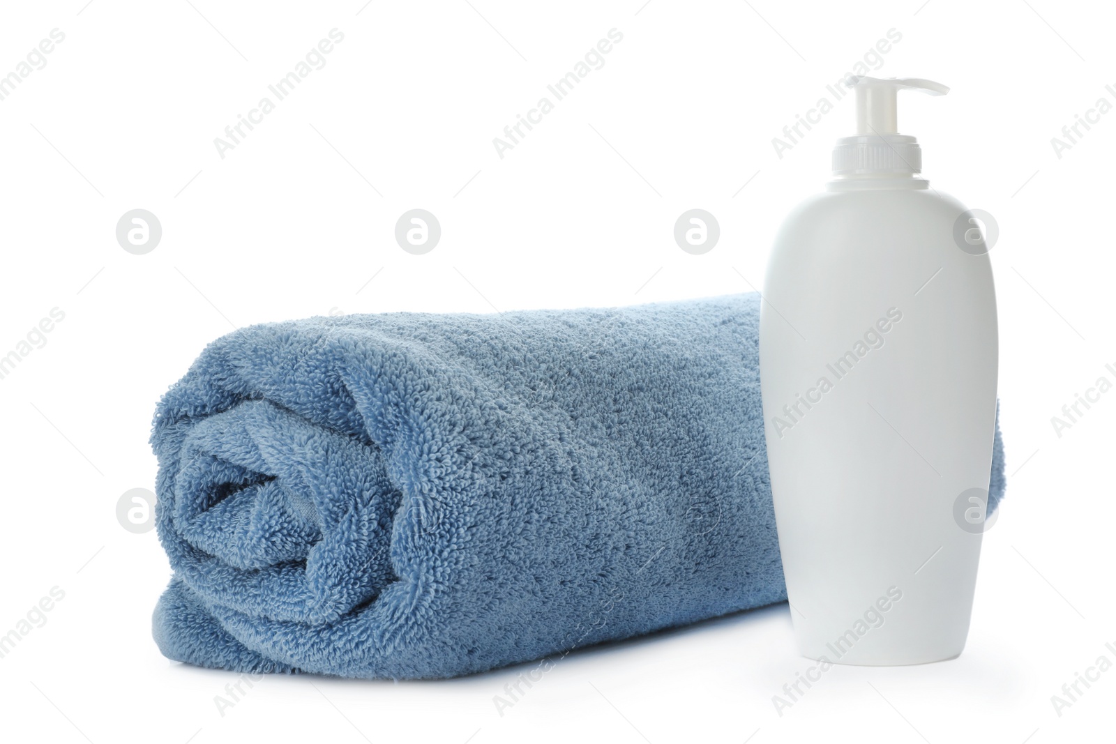 Photo of Rolled towel and shampoo isolated on white