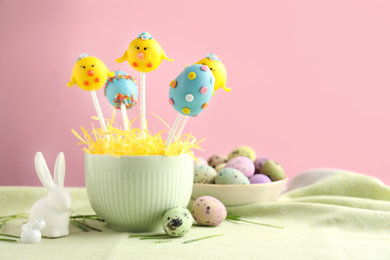 Photo of Delicious sweet cake pops on table, space for text. Easter holiday