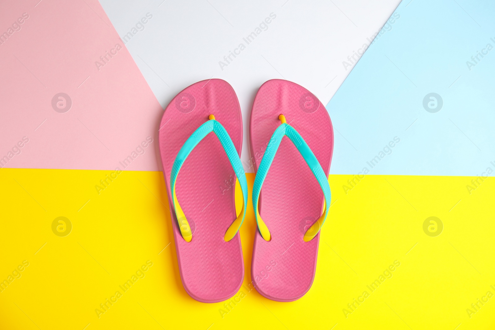 Photo of Flat lay composition with flip flops on color background. Beach objects